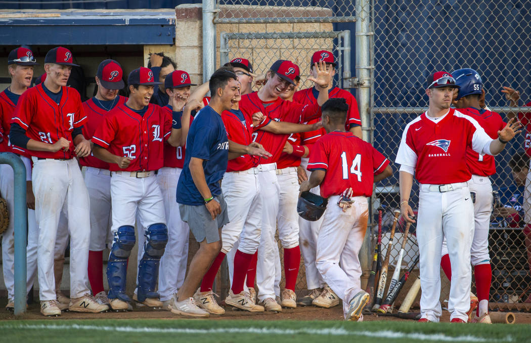 Liberty players celebrate a late-game score by teammate Ryan Towers (14) during the first ro ...