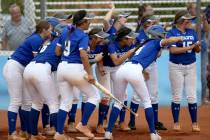 Basic players celebrate a home run by Sierra McClean (12) in the fourth inning of their Dese ...