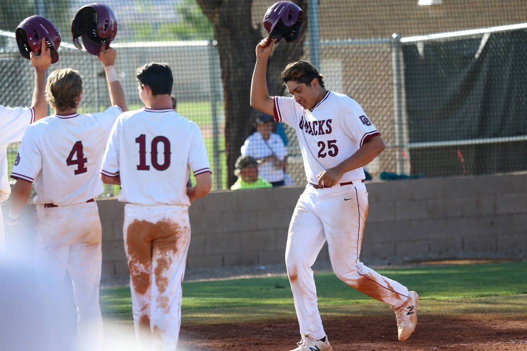 Desert Oasis’ Aaron Roberts (25) runs home after hitting a three run homer against Bas ...