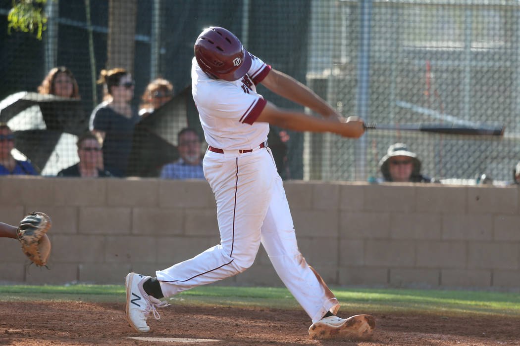 Desert Oasis’ Aaron Roberts (25) swings for a three run homer against Basic in the Des ...
