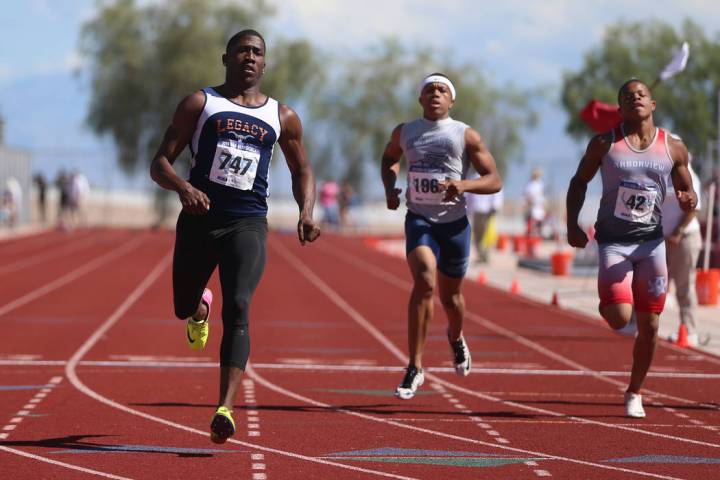 Legacy’s Jerry Martin (747), from left, runs for first place, with Canyon Springs Isai ...