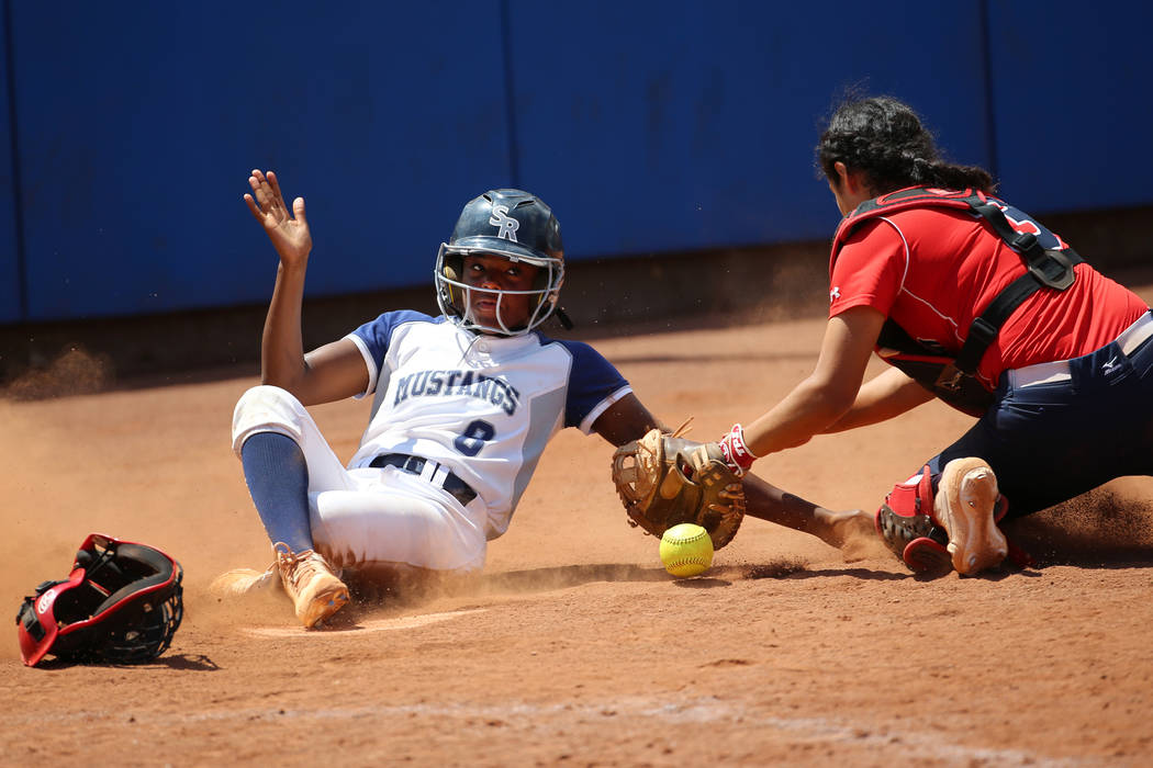 Shadow Ridge’s Jasmine Martin (8) slides safe to home base for a run against Coronado& ...