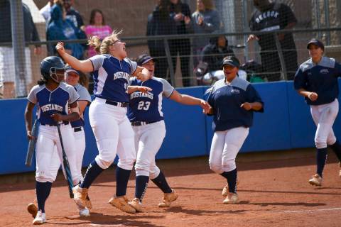 Shadow Ridge players celebrate a home run by Caitlin Covington, not pictured, during the sec ...
