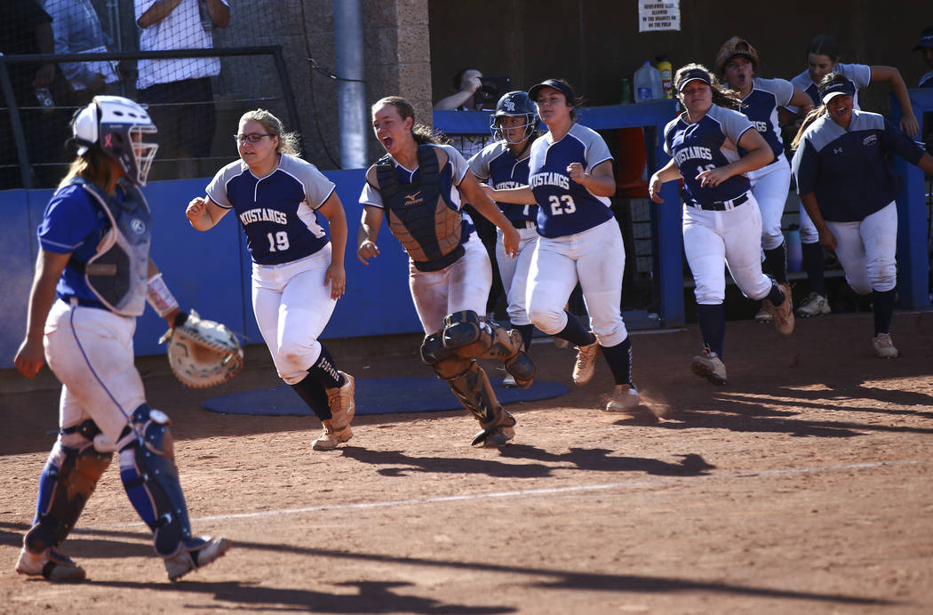 Shadow Ridge players celebrate a run by Alyssa Stanley, not pictured, during the second roun ...