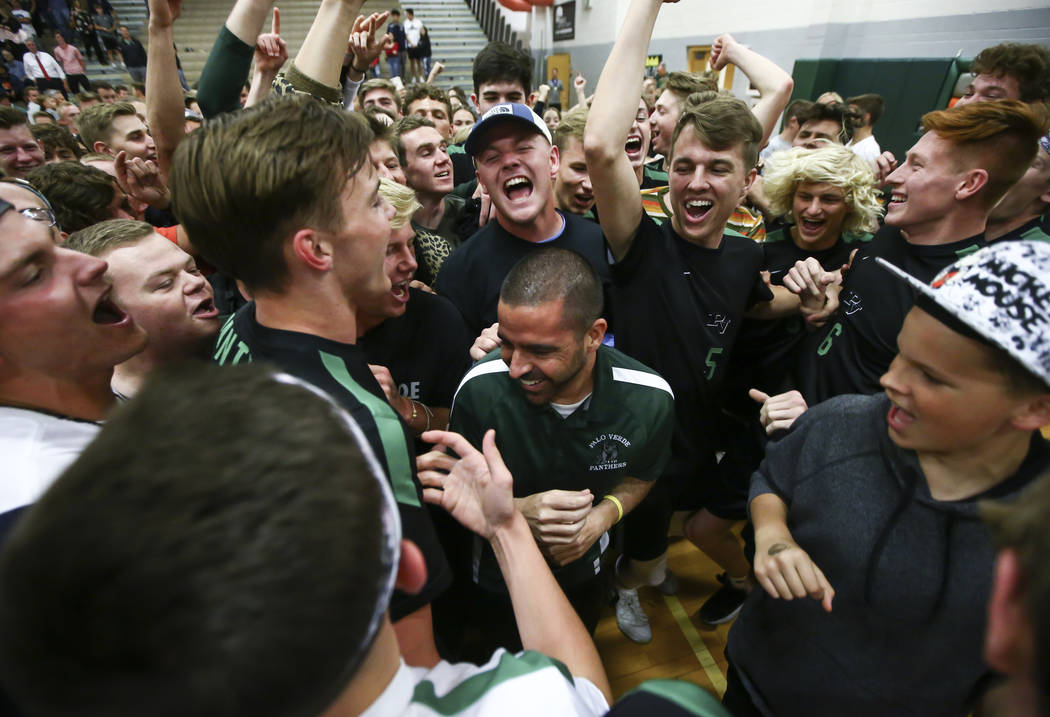 Palo Verde students and players celebrate their victory with head coach Phil Clarke, center, ...