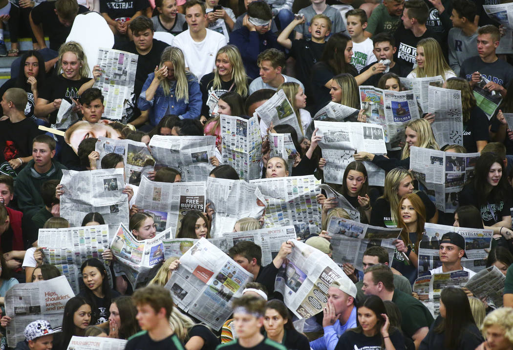 Palo Verde students hold up newspapers as Coronado players are introduced at the start of th ...