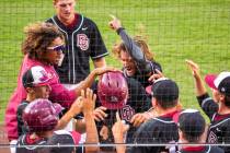 Desert Oasis players congratulate Parker Schmidt (4), center, on another run against Reno d ...