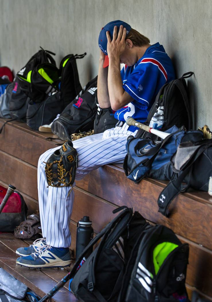 Reno pitcher John Barry (2) gets his head straight in the dugout versus Desert Oasis in the ...