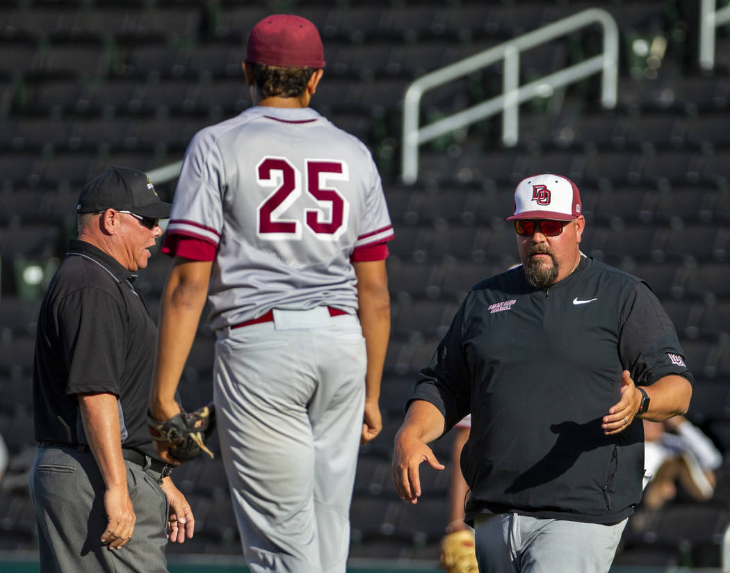 (From right) Desert Oasis head coach Paul Buboltz argues a balk call on his pitcher Aaron Ro ...