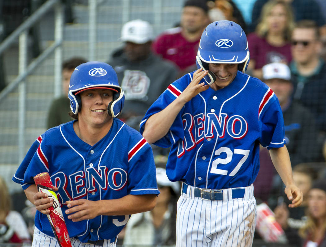 Reno’s Drue Worthen (5) and Jake Novacek (27) look to their teammates as they celebrat ...