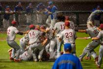 Desert Oasis players celebrate their win over Reno 9-1 during the tie-breaker game of their ...