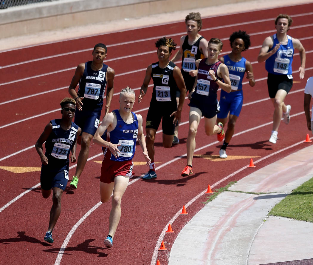 Noah Norris of Centennial, left, and Colby Thomas of Reno battle in the Class 4A 800 meters ...