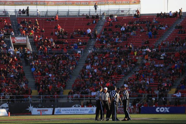 Referees meet at midfield during a tv timeout during the UNLV Nevada football game at Sam Boyd ...