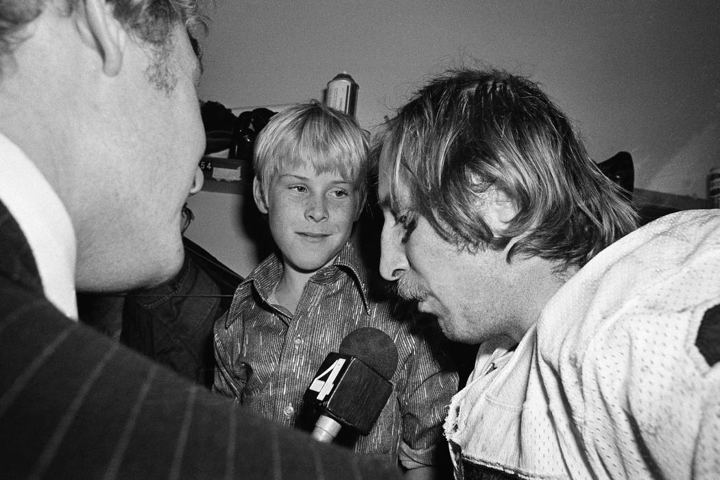 Ten-year-old Fred Biletnikoff Jr., center, looks in admiration at his father, one of the sta ...