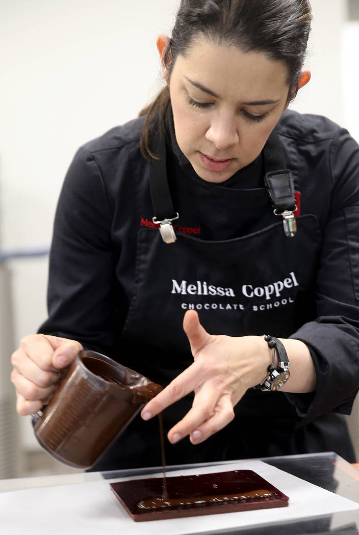 Melissa Coppel makes chocolate at her Las Vegas chocolate school Thursday, May 16, 2019. At lef ...