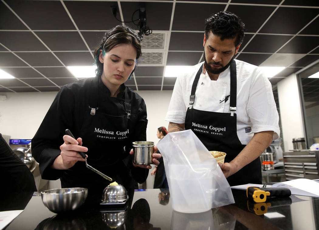 Students Rebecca Travers of Denver and Evin Breton of New York make chocolate creations at Meli ...