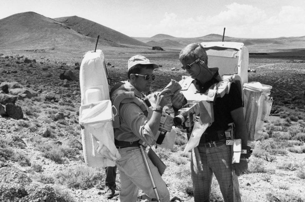 Apollo 17 lunar module pilot Jack Schmitt, left, and commander Gene Cernan examine a rock sampl ...