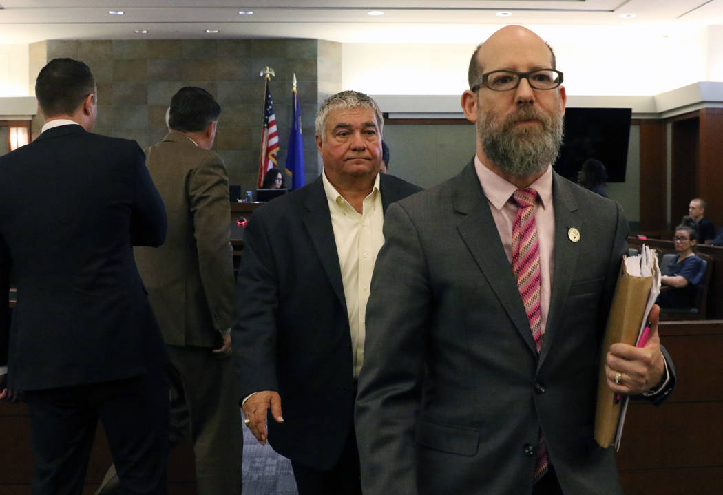 Former Henderson Constable Earl Mitchell, left, leaves the courtroom with his attorney David Fi ...