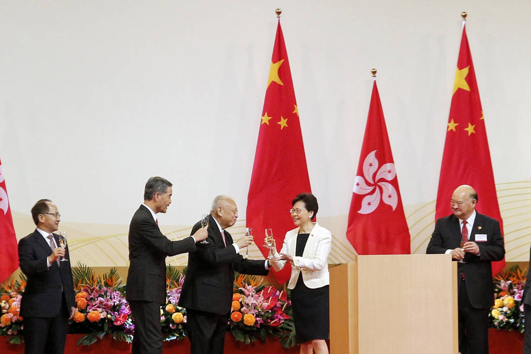 Hong Kong Chief Executive Carrie Lam, second right, toasts with former Chief Executives Tung Ch ...