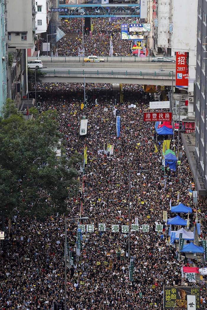 Ten of thousands of protesters flood the streets as they take part in a rally Monday, July 1, 2 ...