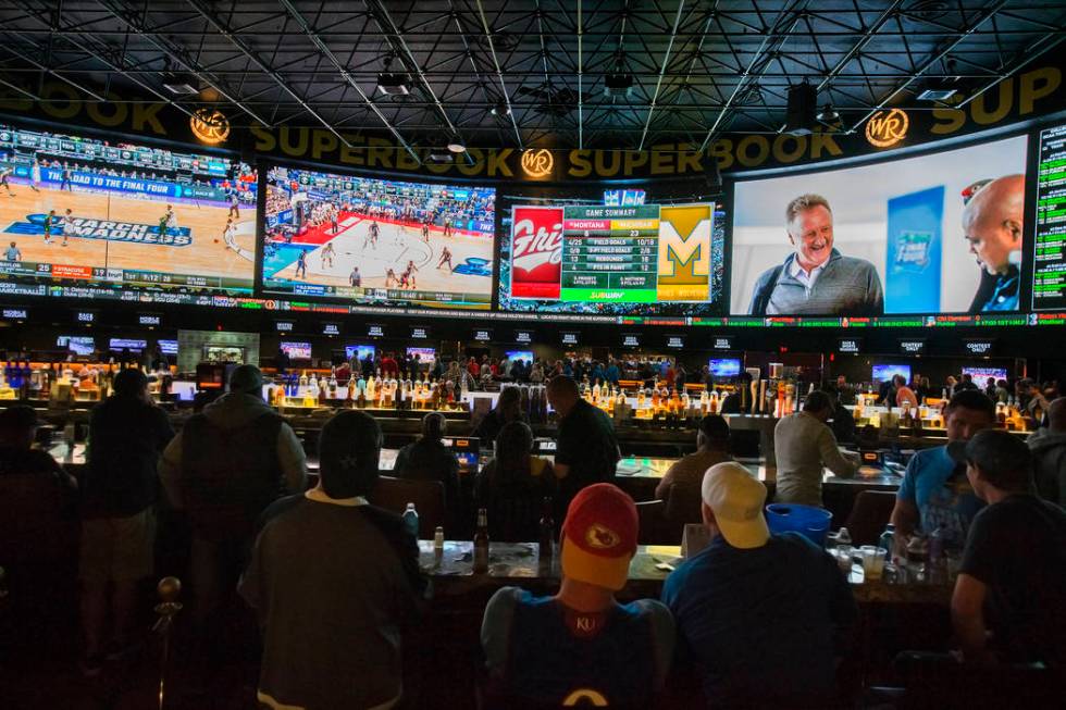 Basketball fans take in the first day of the NCAA Tournament at the Westgate Sportsbook on Thur ...