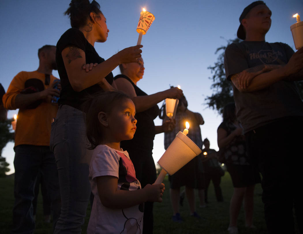 Ripley Rose Garcia, 2, holds a candle during a vigil for her father, Max Garcia, on Monday, Jul ...