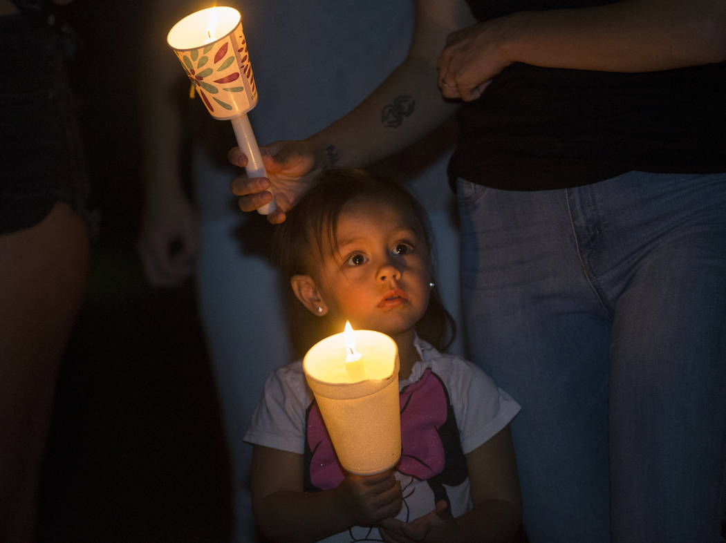 Ripley Rose Garcia, 2, holds a candle during a vigil for her father Max Garcia on Monday, July ...