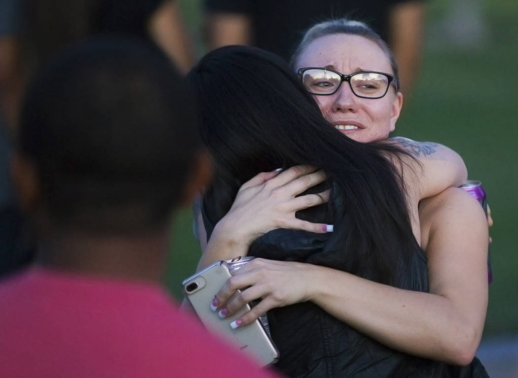 Brittney Black is comforted by a friend during a vigil for her friend Max Garcia on Monday, Jul ...
