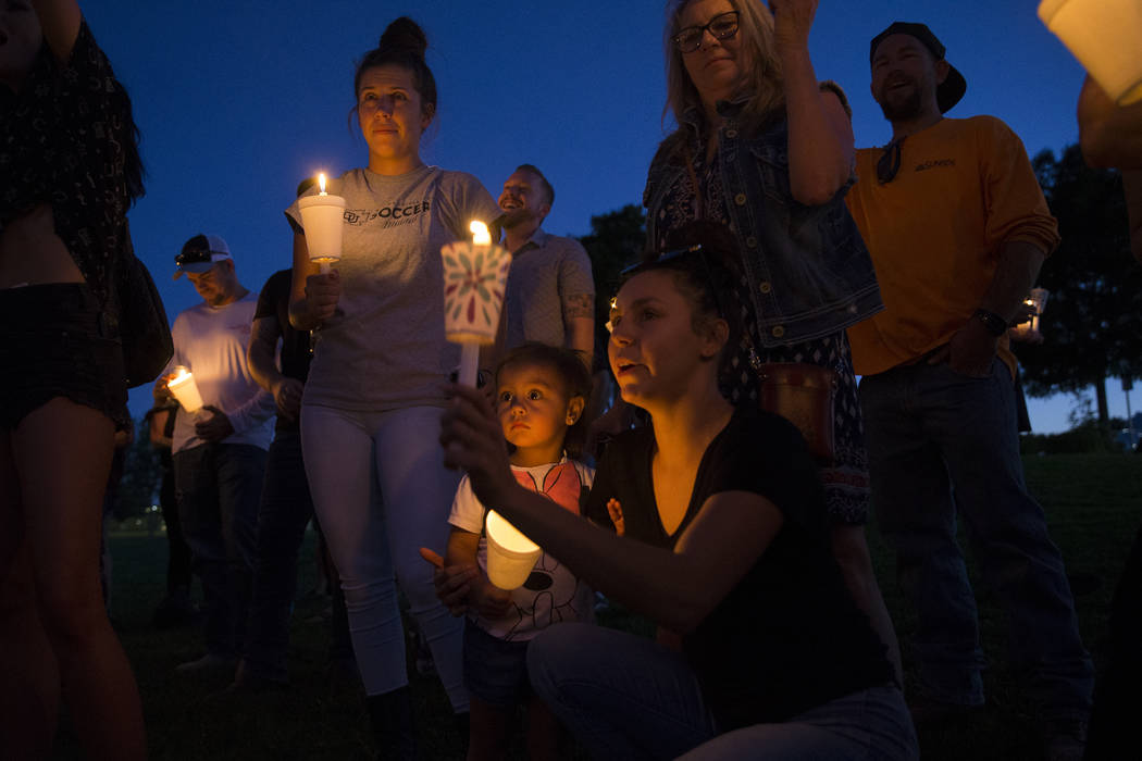 Ripley Rose Garcia, 2, stands with her mother, Alexis Mendoza, right, during a vigil for her fa ...