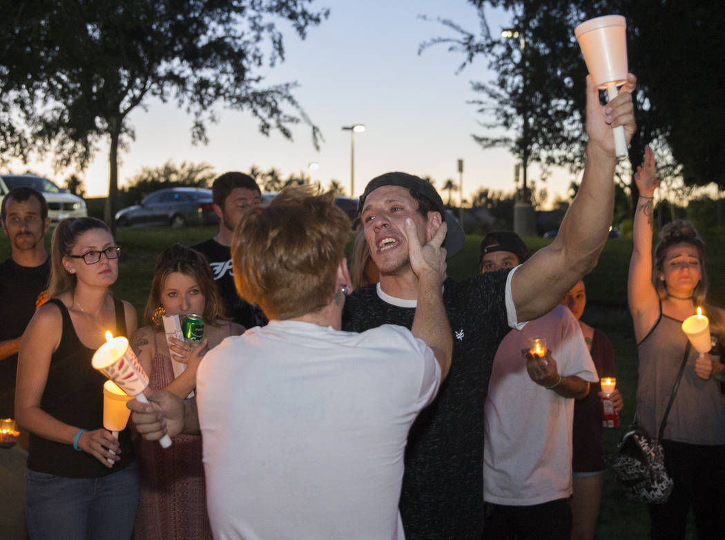 Christian Fitzpatrick, right, is comforted by his brother Casey Fitzpatrick during a vigil on M ...