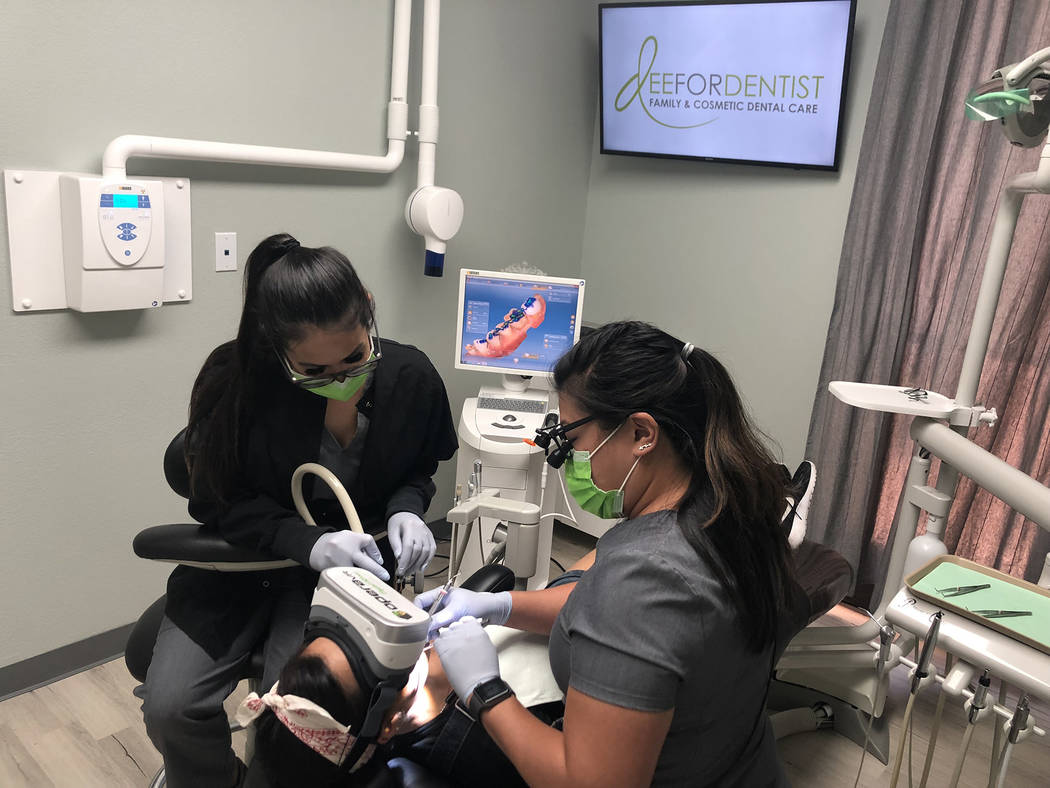 Dr. Dee Dee Meevasin, right, is the first dentist in Las Vegas to use OperaVR to help ease pati ...