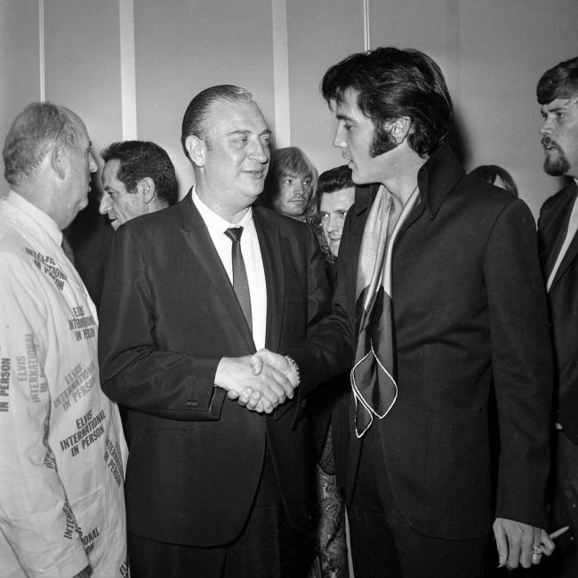 Elvis Presley is greeted by comedian Rodney Dangerfield, left, at the International Hotel in La ...