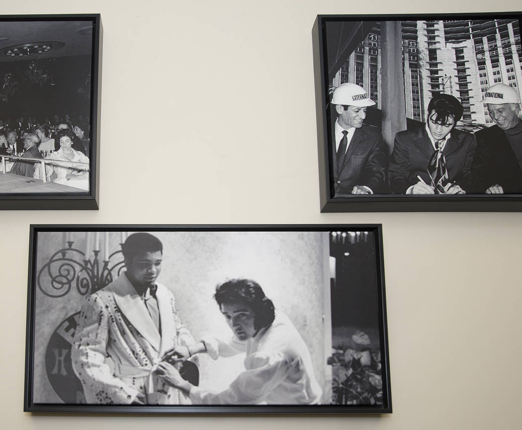 Prints of famous photographs of Elvis Presley hang on the wall in the administrative offices of ...