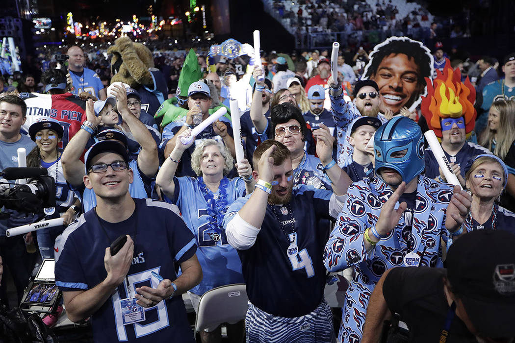 Fans watch the action on the main stage during the first round at the NFL football draft, Thurs ...