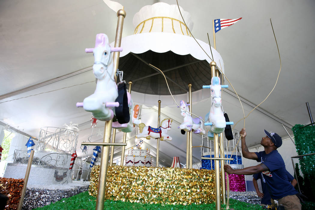 Isiah Powell works on the "Mary Poppins Jolly Holiday" float during a media preview of the 25th ...