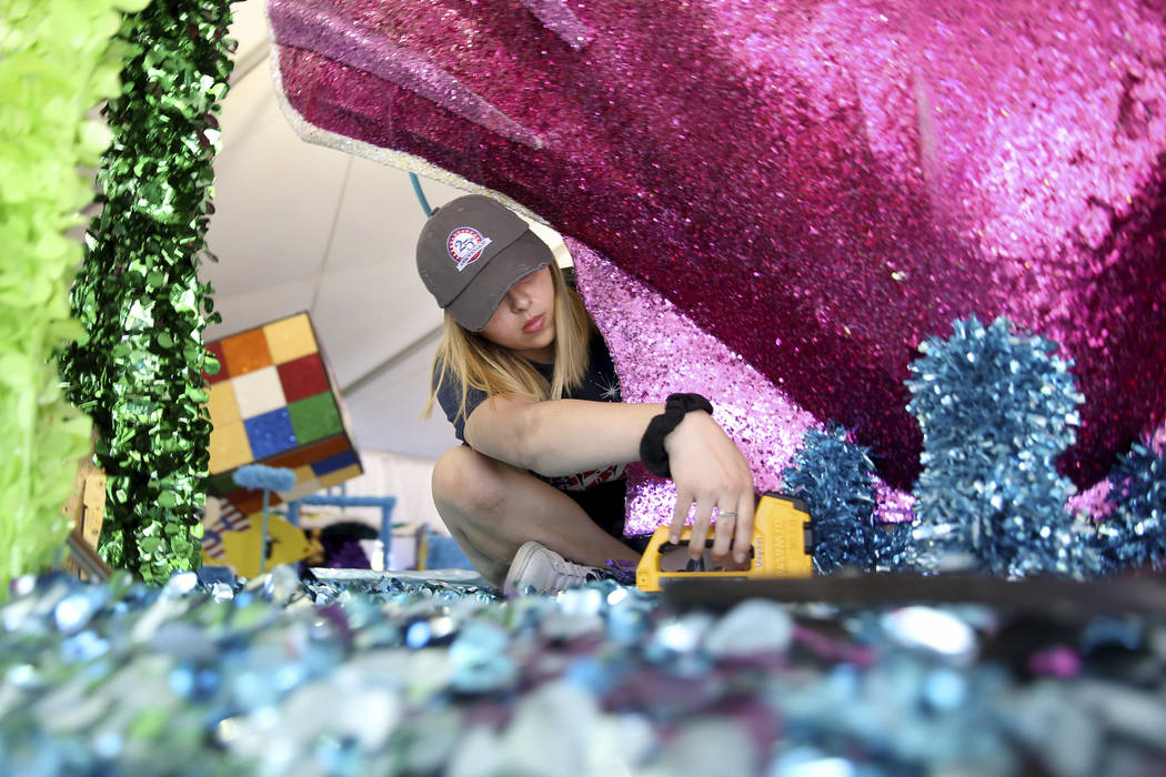 Jordyn Doyle works on the "Undersea Jubilee" float during a media preview of the 25th annual Su ...