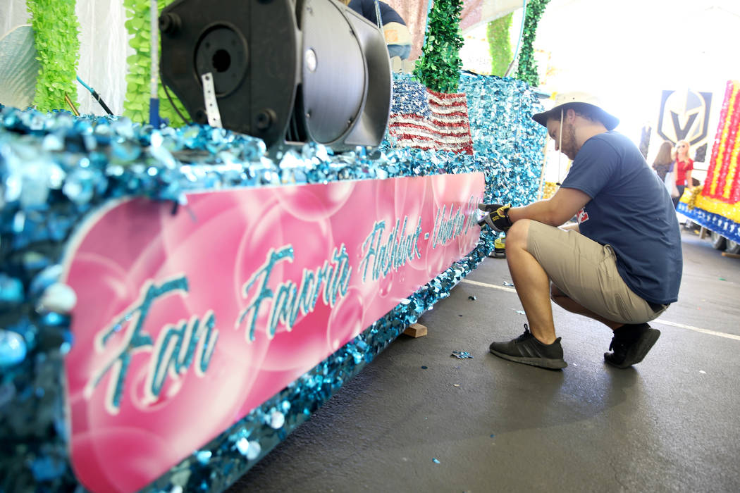 Julien Mihy works on the "Undersea Jubilee" float during a media preview of the 25th annual Sum ...
