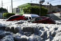 In this photo released by Jalisco State Civil Defense Agency, cars are suspended in hail in Gua ...