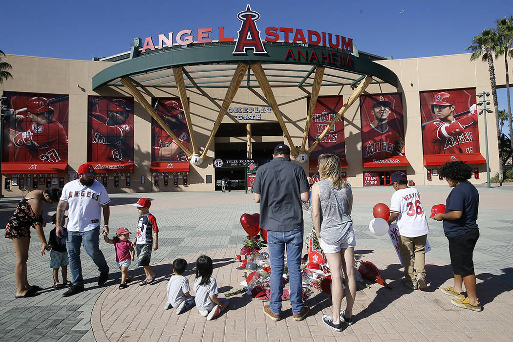Los Angeles Angel mourners stand at a memorial to give their condolences for pitcher Tyler Skag ...
