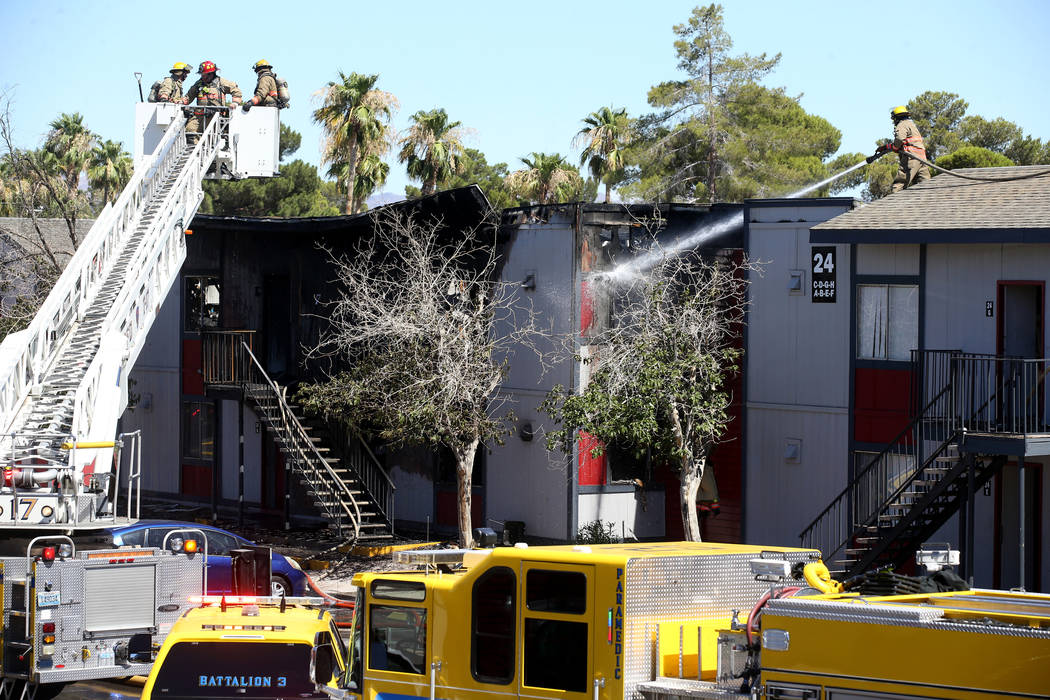 Clark County firefighters douse a three-alarm fire at an apartment complex at 5100 E. Tropicana ...