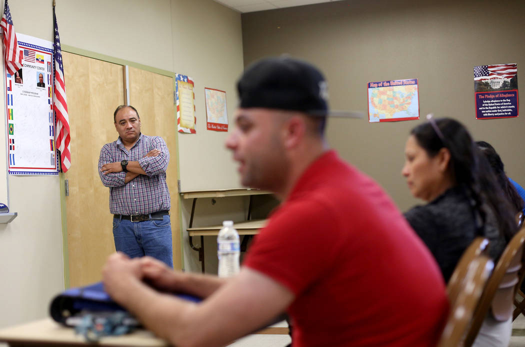 Teacher Gonzalo Comelo listens to Walter Salguero answer questions at the Stupak Community Cent ...