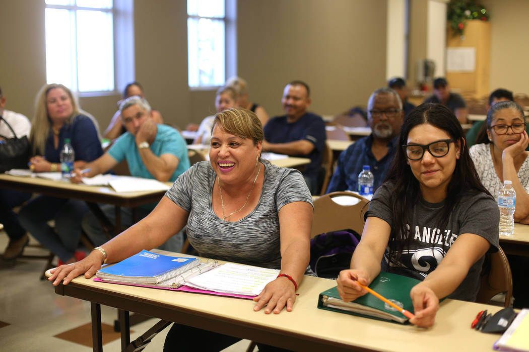 Amelia Guerrero, left, laughs next to Lisbeth Calderon, right, as she answers questions at the ...