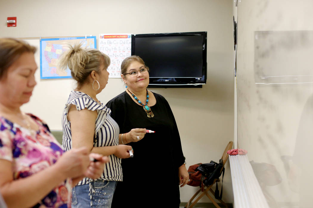 Mayra Crum, right, speaks to Maria Valdespino at the city's citizenship class at the Stupak Com ...