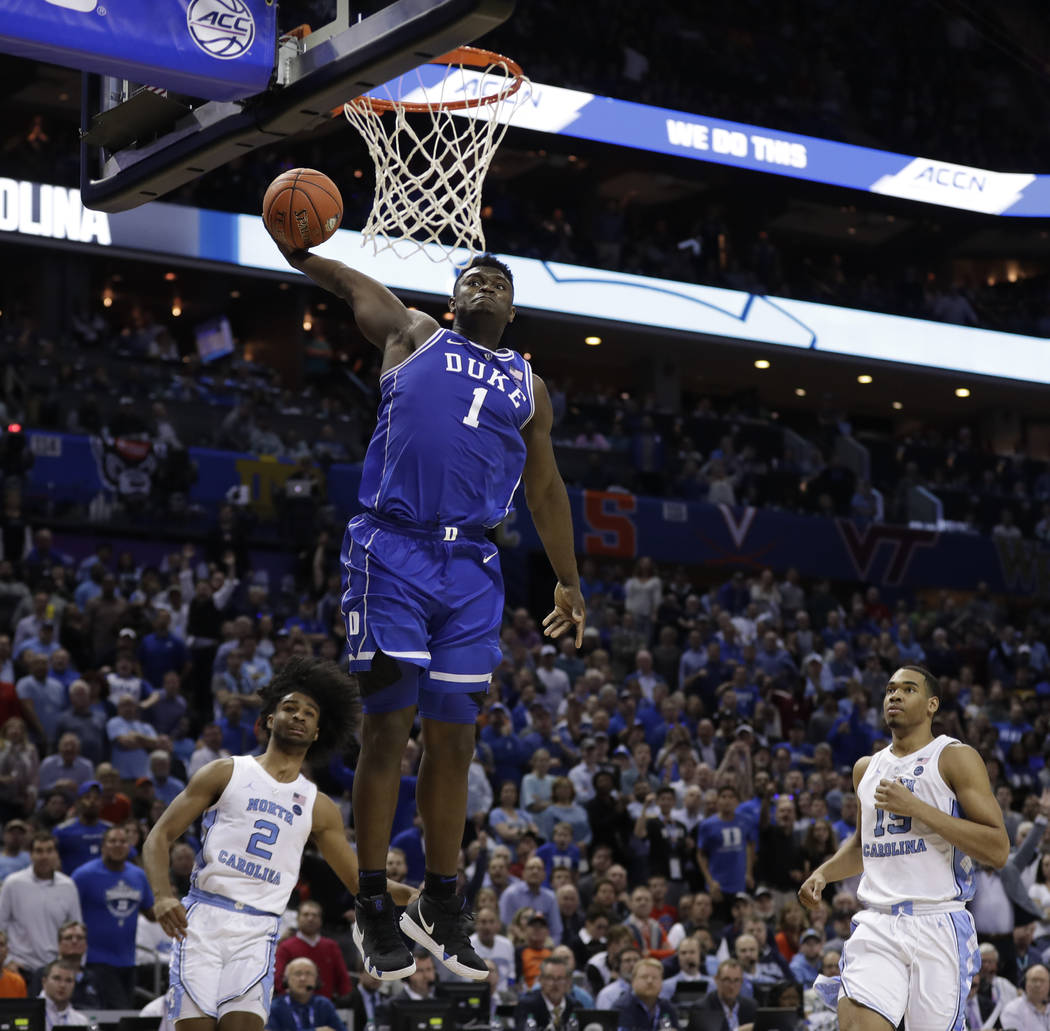 Duke's Zion Williamson (1) dunks against North Carolina during the second half of an NCAA colle ...