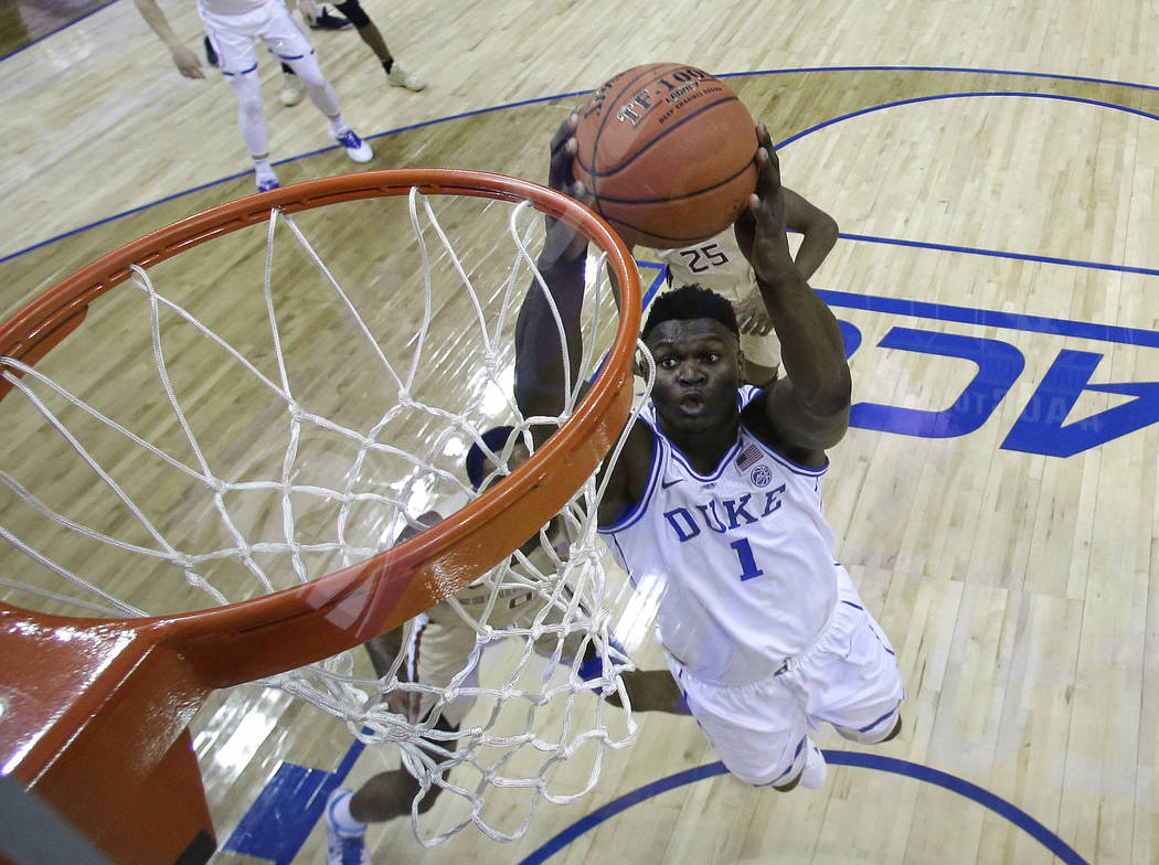 Duke's Zion Williamson (1) goes up to dunk against Florida State during the first half of the N ...