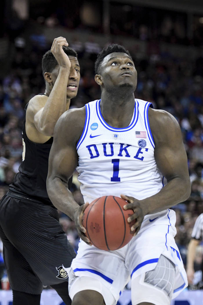 Duke forward Zion Williamson (1) drives to the hoop against Central Florida guard Aubrey Dawkin ...