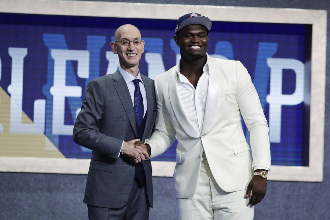 Duke's Zion Williamson, right, poses for photographs with NBA Commissioner Adam Silver after be ...