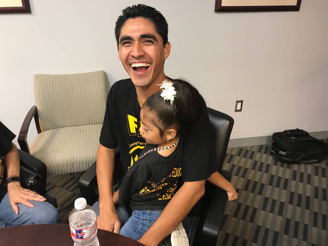 Jose Escobar holds his daughter Carmen shortly after returning to the United States at Houston& ...