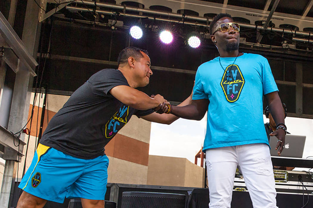 Las Vegas Lights FC assistant head coach Auggie Rodriguez, left, greets hype man Robert "Bojo" ...