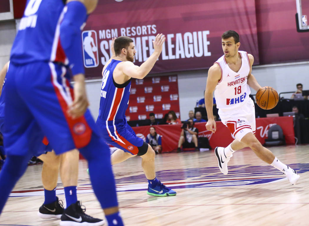 Croatia's Roko Badzim (18) moves the ball past Detroit Pistons' Sviatoslav Mykhailiuk during th ...